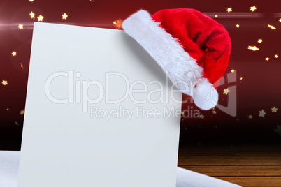 Composite image of santa hat on poster