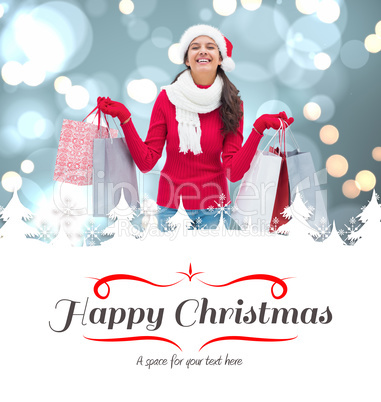 Composite image of festive brunette holding shopping bags