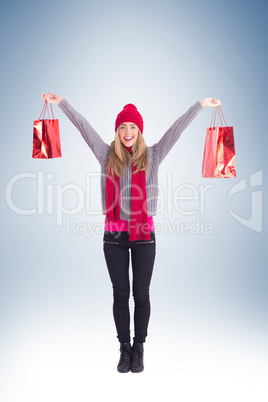 Festive blonde holding shopping bags