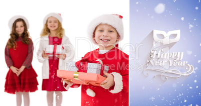Composite image of festive little siblings smiling at camera hol