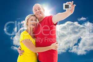 Composite image of happy mature couple taking a selfie together