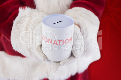 Composite image of santa holds a can for donations