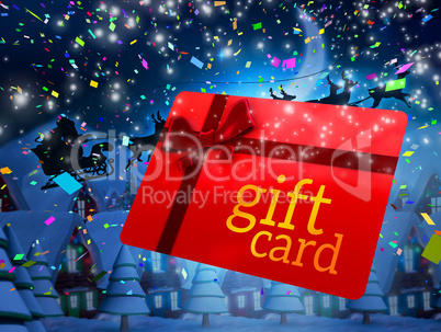 Composite image of santa flying his sleigh behind gift card