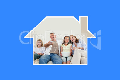 Composite image of family on the sofa watching tv