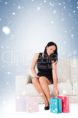 Woman sitting with shopping bags