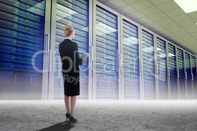 Composite image of businesswoman holding new tablet