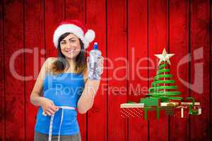 Composite image of festive fit brunette measuring her waist and