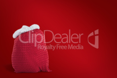 Composite image of santas red bag standing alone