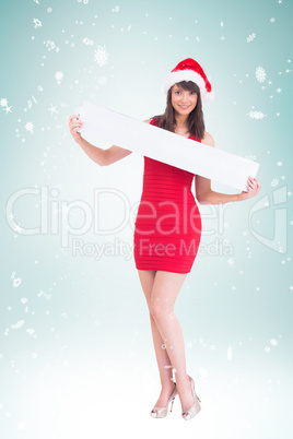 Composite image of festive brunette showing a blank banner