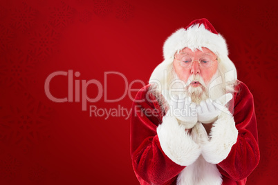 Composite image of santa claus blows something away