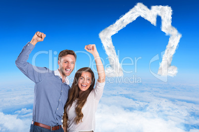 Composite image of happy young couple cheering