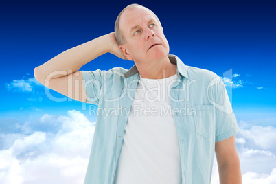 Composite image of thoughtful older man looking up