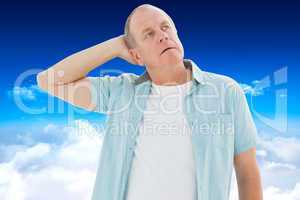 Composite image of thoughtful older man looking up