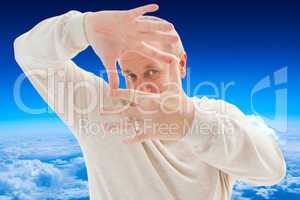 Composite image of happy mature man framing with hands