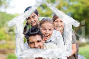 Composite image of happy family in the park