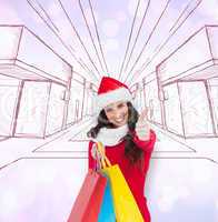 Composite image of festive brunette holding gifts and thumb up