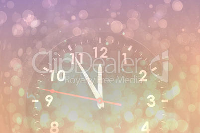 Composite image of clock counting down to midnight