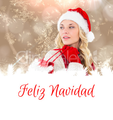 Composite image of happy festive blonde with shopping bag