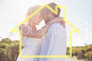 Composite image of attractive couple embracing by the road