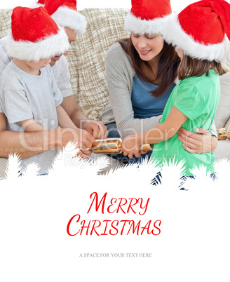 Composite image of family opening crackers together on the sofa