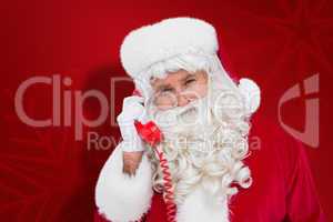 Composite image of santa claus on the phone