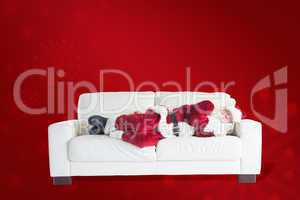 Composite image of father christmas sleeps on a couch
