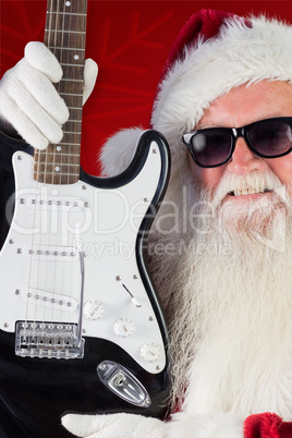 Composite image of father christmas shows a guitar