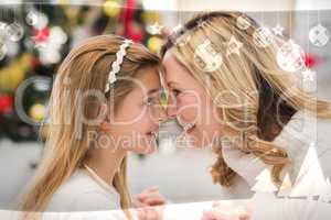 Composite image of festive mother and daughter beside christmas