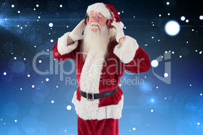 Composite image of santa claus enjoys some music