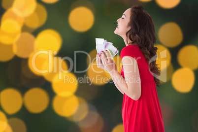 Composite image of stylish brunette in red dress holding cash