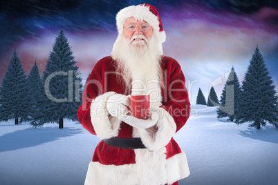 Composite image of santa holds a red cup