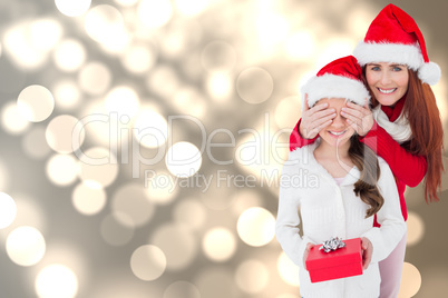 Composite image of mother and daughter with gift Composite image of mother and daughter with gift