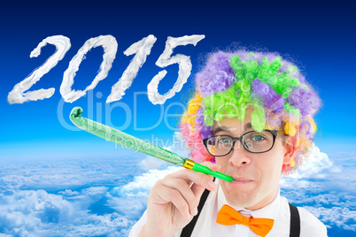 Composite image of geek blowing party horn