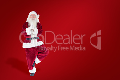 Composite image of father christmas doing some yoga