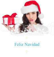 Composite image of festive brunette holding gift and keeping a s