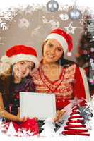 Composite image of festive mother and daughter showing tablet screen