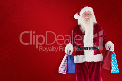 Composite image of santa carries some christmas bags