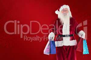 Composite image of santa carries some christmas bags