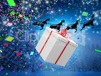 Composite image of santa flying his sleigh behind a big gift