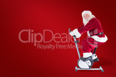 Composite image of santa uses a home trainer