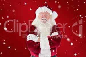 Composite image of santa smiles with folded arms