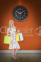 Composite image of elegant blonde with shopping bags