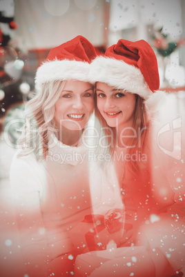 Composite image of festive mother and daughter smiling at camera