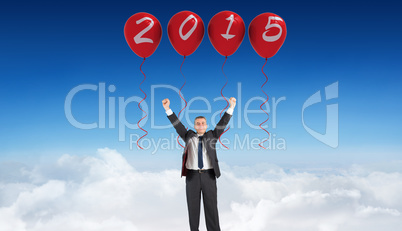 Composite image of mature businessman cheering with arms up