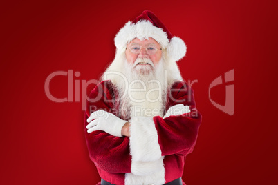 Composite image of santa smiles with folded arms