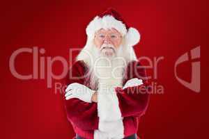 Composite image of santa smiles with folded arms