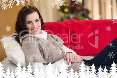 Composite image of happy brunette relaxing on the couch at chris