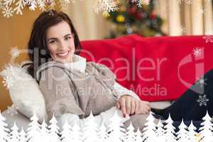 Composite image of happy brunette relaxing on the couch at chris