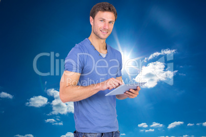 Composite image of man scrolling through tablet pc