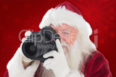 Composite image of santa is taking a picture